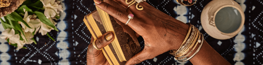A pair of hands about to layout a tarot spread.  
