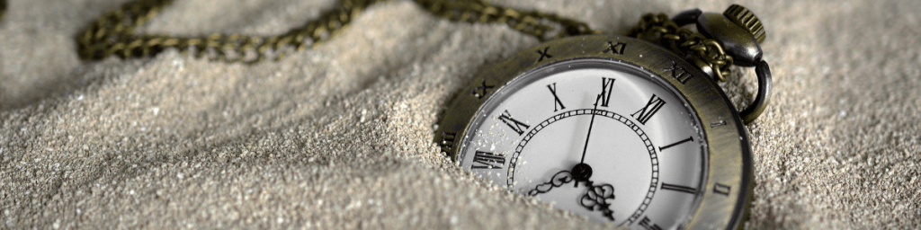 Pocket watch in sand.
