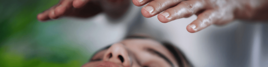 Image of energy healer with hands over a person's head